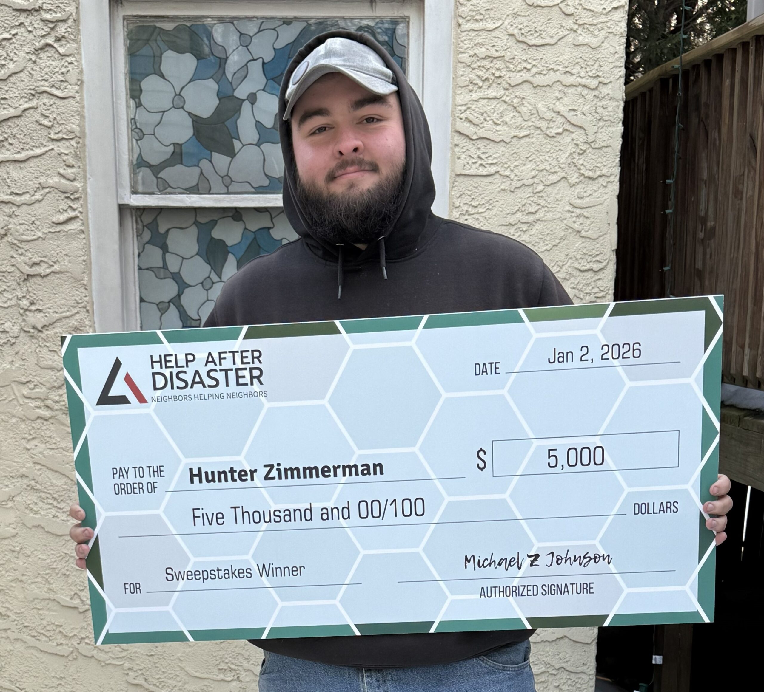 Hunter Zimmerman holding his prize check