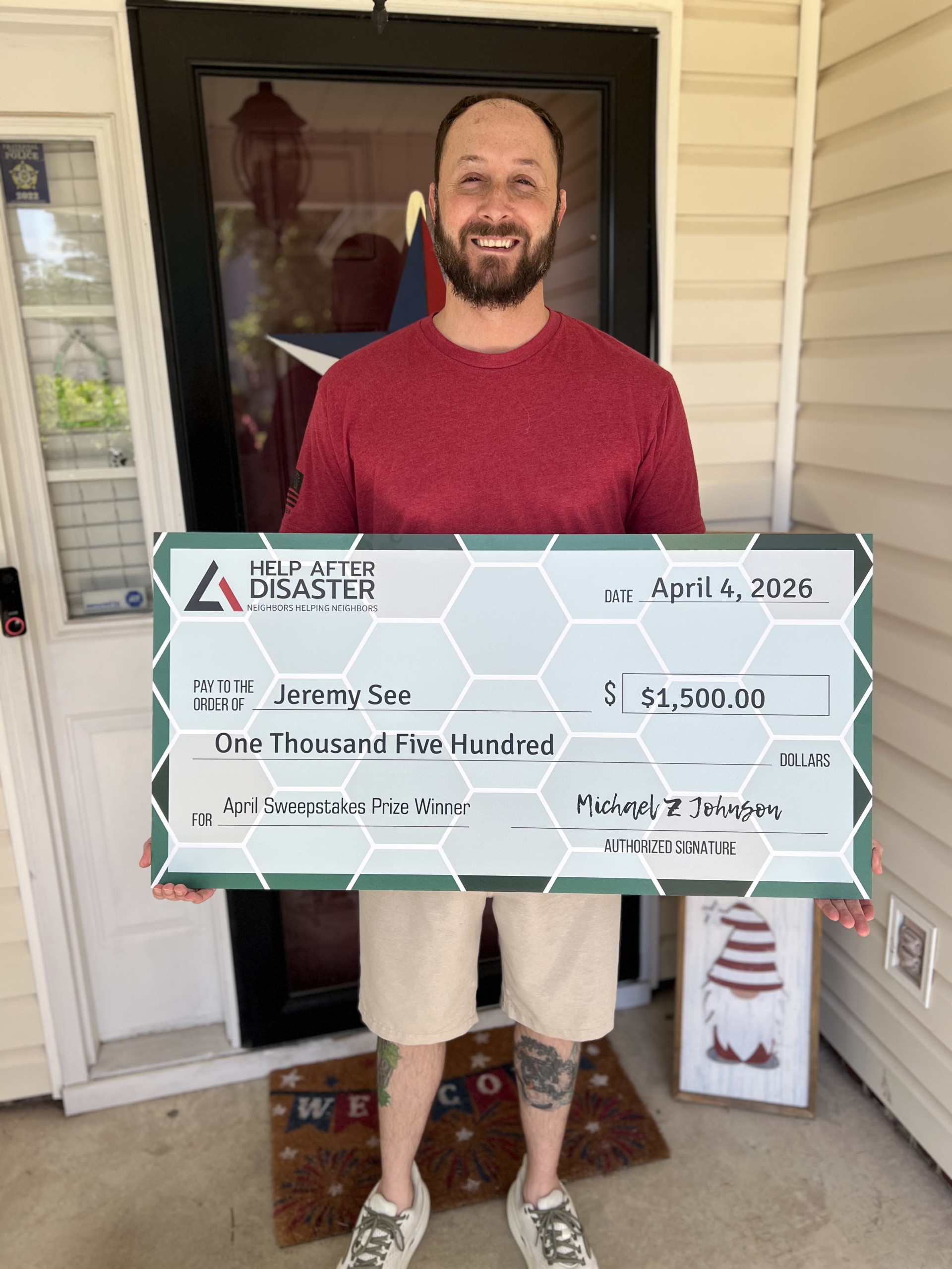 Jeremy See holding his prize check