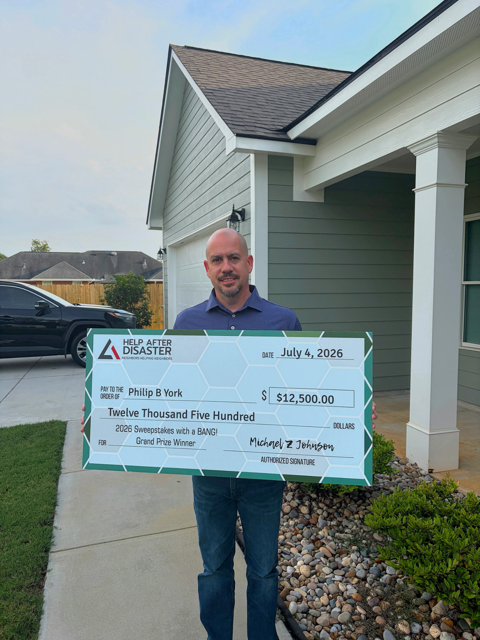 Philip B York holding his prize check